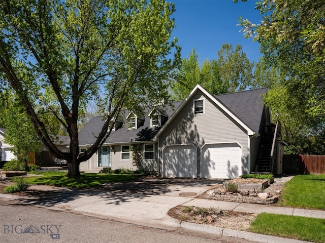 507 Flathead Ave, Bozeman, MT 59718 - cape cod home with a garage, driveway, and a shingled roof
