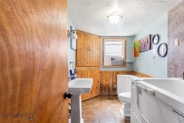 1408 Dewey Blvd, Butte, MT 59701 - bathroom with wooden walls, toilet, washer / clothes dryer, and cooling unit