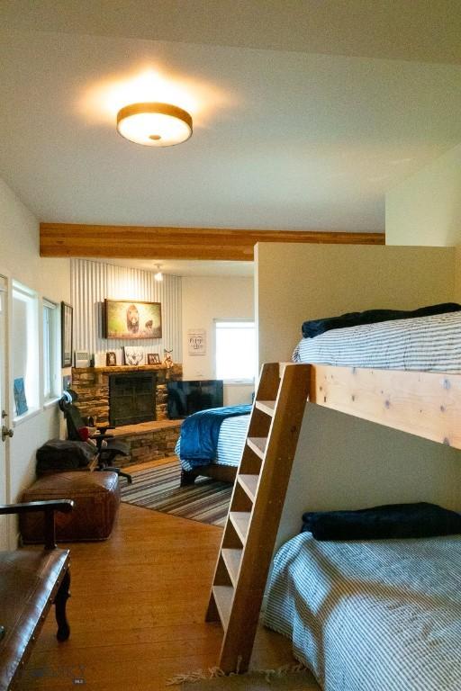 202 Beach Dr, West Yellowstone, MT 59758 - bedroom with wood finished floors and a fireplace