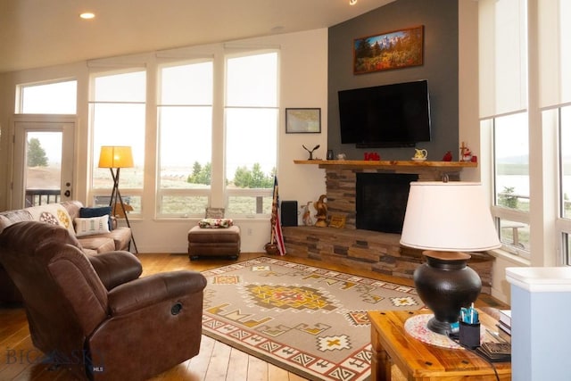 202 Beach Dr, West Yellowstone, MT 59758 - living room with hardwood / wood-style flooring, a fireplace, lofted ceiling, and recessed lighting
