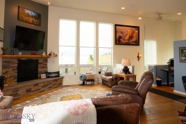 202 Beach Dr, West Yellowstone, MT 59758 - living room featuring wood-type flooring, plenty of natural light, a fireplace, a ceiling fan, and recessed lighting