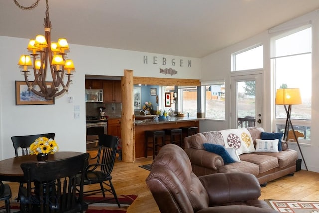 202 Beach Dr, West Yellowstone, MT 59758 - living room featuring a chandelier and light wood-style flooring