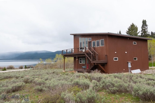 202 Beach Dr, West Yellowstone, MT 59758 - view of side of home with stairway and a deck with water view
