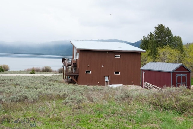 202 Beach Dr, West Yellowstone, MT 59758 - view of home's exterior featuring a deck with water view and stairs