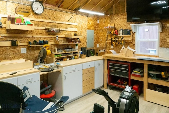 202 Beach Dr, West Yellowstone, MT 59758 - miscellaneous room featuring a workshop area, light wood finished floors, and electric panel