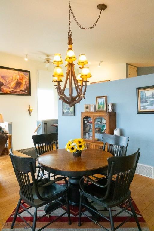 202 Beach Dr, West Yellowstone, MT 59758 - dining room featuring a chandelier and wood finished floors