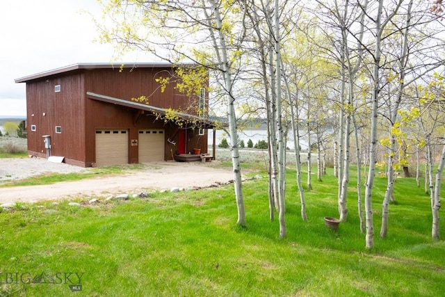 202 Beach Dr, West Yellowstone, MT 59758 - view of green lawn with an outdoor structure and a water view