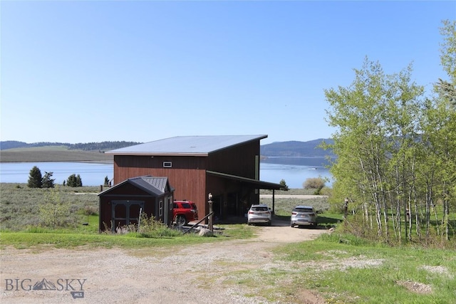 202 Beach Dr, West Yellowstone, MT 59758 - view of outbuilding featuring a water view and driveway
