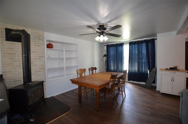 314 S Dakota St, Dillon, MT 59725 - dining room featuring a wood stove, dark wood-style floors, a ceiling fan, and built in shelves