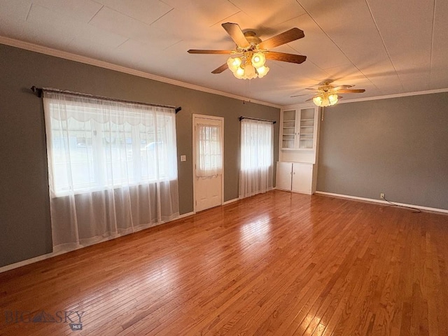 330 N Walnut St, Dillon, MT 59725 - spare room with a ceiling fan, plenty of natural light, wood finished floors, and crown molding