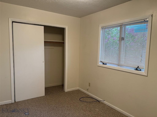 330 N Walnut St, Dillon, MT 59725 - unfurnished bedroom featuring carpet floors, a closet, baseboards, and a textured ceiling