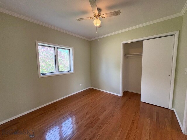 330 N Walnut St, Dillon, MT 59725 - unfurnished bedroom with wood finished floors, ornamental molding, baseboards, a closet, and ceiling fan