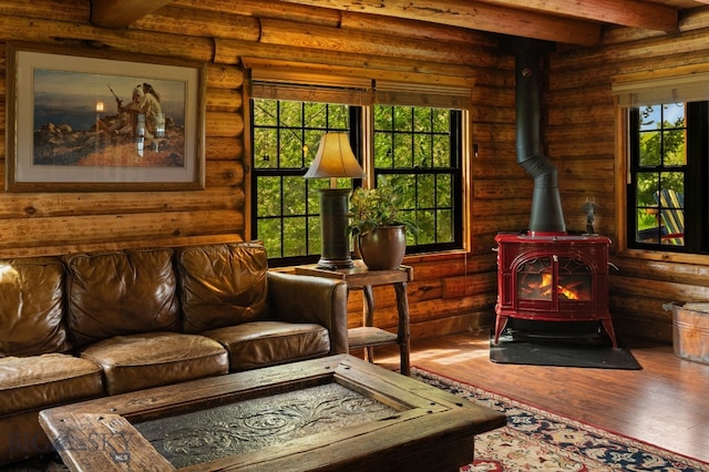 25 Big Chief Trl, Bozeman, MT 59718 - living room with a wood stove, wood finished floors, beamed ceiling, and rustic walls