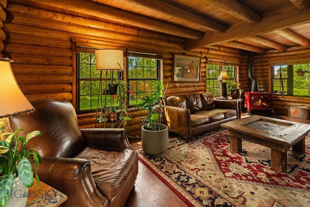 25 Big Chief Trl, Bozeman, MT 59718 - living room featuring a wood stove, rustic walls, a wooden ceiling with exposed beams, healthy amount of natural light, and hardwood / wood-style flooring
