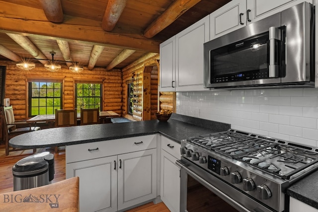 25 Big Chief Trl, Bozeman, MT 59718 - kitchen with appliances with stainless steel finishes, log walls, a peninsula, wooden ceiling with exposed beams, and white cabinetry