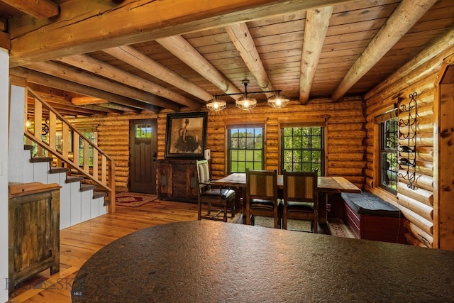 25 Big Chief Trl, Bozeman, MT 59718 - dining room featuring log walls, wooden ceiling with exposed beams, hardwood / wood-style flooring, and stairway