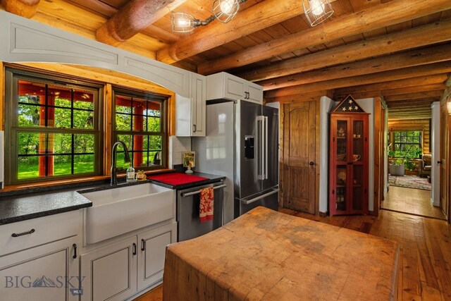 25 Big Chief Trl, Bozeman, MT 59718 - kitchen with appliances with stainless steel finishes, a wooden ceiling with exposed beams, wood-type flooring, and white cabinetry