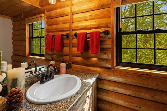 25 Big Chief Trl, Bozeman, MT 59718 - bathroom featuring log walls, vanity, and wooden ceiling