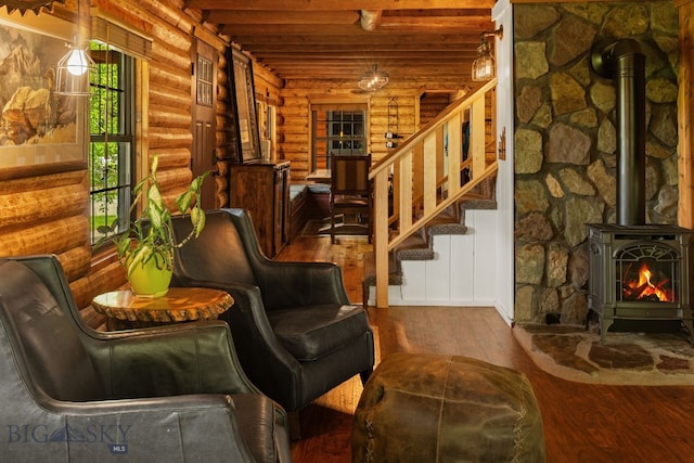 25 Big Chief Trl, Bozeman, MT 59718 - living area with log walls, hardwood / wood-style floors, a wood stove, and stairway