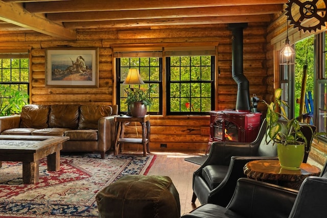 25 Big Chief Trl, Bozeman, MT 59718 - living room with a wood stove, rustic walls, hardwood / wood-style flooring, beamed ceiling, and healthy amount of natural light