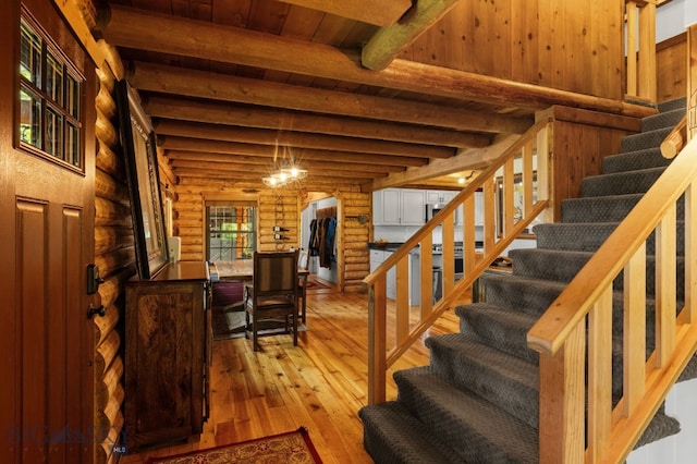 25 Big Chief Trl, Bozeman, MT 59718 - stairway with rustic walls, arched walkways, wood-type flooring, and a wood ceiling with exposed beams