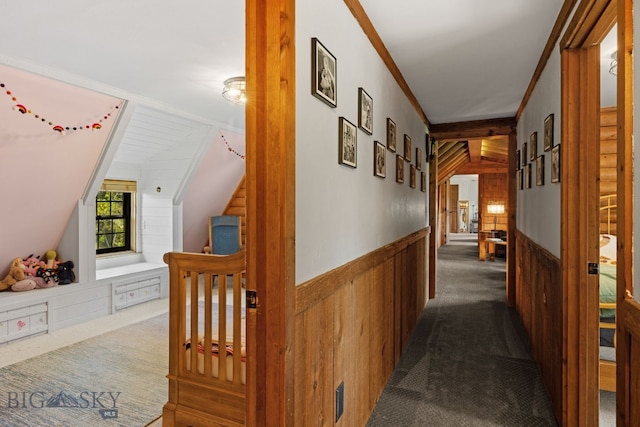 25 Big Chief Trl, Bozeman, MT 59718 - hallway with dark colored carpet, wainscoting, vaulted ceiling, ornamental molding, and wood walls