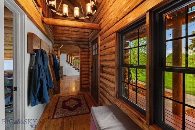 25 Big Chief Trl, Bozeman, MT 59718 - entryway featuring rustic walls, a chandelier, wood-type flooring, wood ceiling, and stairs