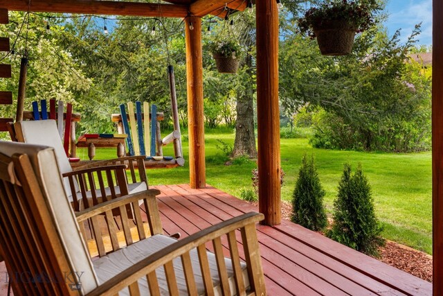 25 Big Chief Trl, Bozeman, MT 59718 - wooden terrace featuring a lawn and view of wooded area