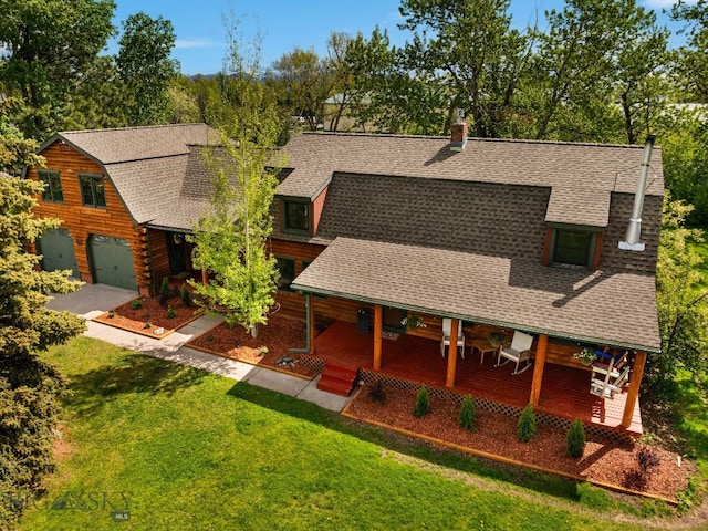 25 Big Chief Trl, Bozeman, MT 59718 - view of front of house with a shingled roof, a front lawn, a garage, and a chimney
