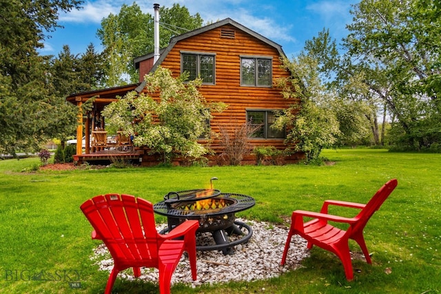 25 Big Chief Trl, Bozeman, MT 59718 - rear view of house with a fire pit, a gambrel roof, a yard, and log siding