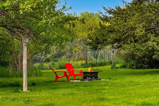 25 Big Chief Trl, Bozeman, MT 59718 - view of green lawn with an outdoor fire pit