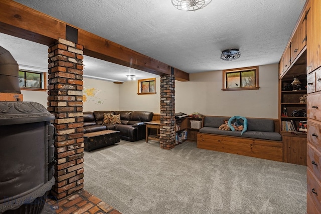 25 Big Chief Trl, Bozeman, MT 59718 - carpeted living area with ornate columns, a textured ceiling, and beamed ceiling
