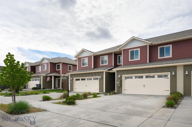 1304 Glider Ln Unit B, Belgrade, MT 59714 - view of property featuring board and batten siding, a garage, driveway, and a residential view