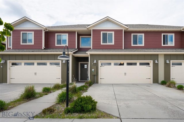 1304 Glider Ln Unit B, Belgrade, MT 59714 - townhome / multi-family property with board and batten siding, a garage, driveway, and roof with shingles