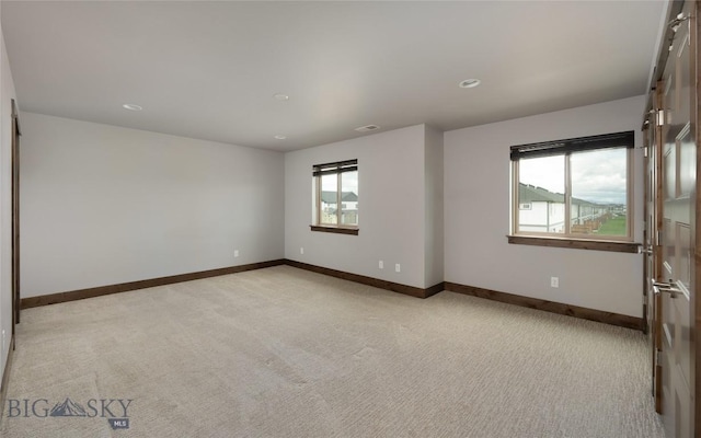 1304 Glider Ln Unit B, Belgrade, MT 59714 - empty room featuring light carpet, baseboards, and recessed lighting