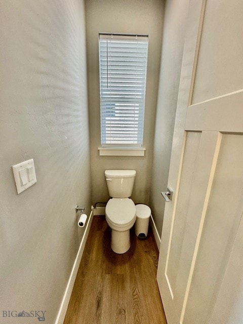 920 Butler Creek Ave, Belgrade, MT 59714 - bathroom with wood finished floors, toilet, and baseboards