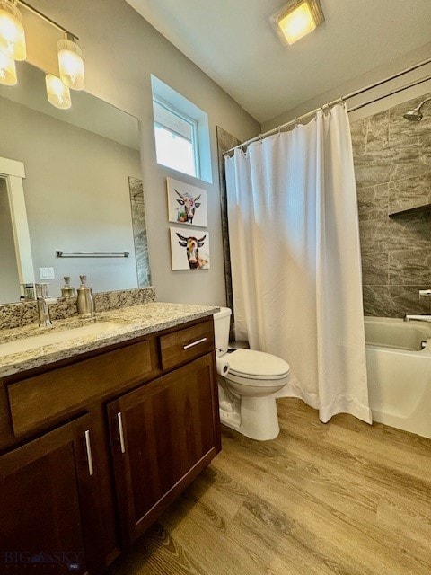 920 Butler Creek Ave, Belgrade, MT 59714 - bathroom featuring wood finished floors, vanity, toilet, and shower / tub combo