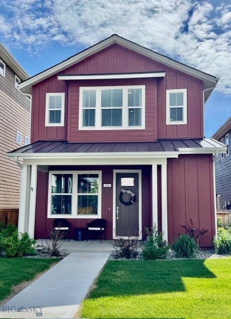 920 Butler Creek Ave, Belgrade, MT 59714 - view of front of property with a standing seam roof, covered porch, board and batten siding, and a front lawn