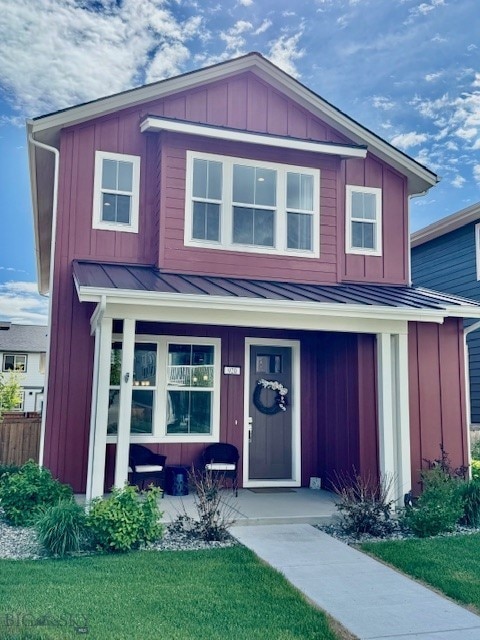 920 Butler Creek Ave, Belgrade, MT 59714 - view of front of property featuring a porch, a standing seam roof, board and batten siding, metal roof, and a front lawn
