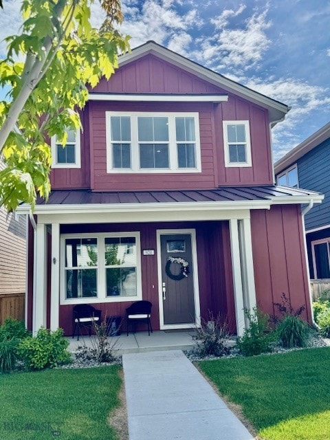 920 Butler Creek Ave, Belgrade, MT 59714 - view of front of property featuring a standing seam roof, a porch, board and batten siding, and metal roof