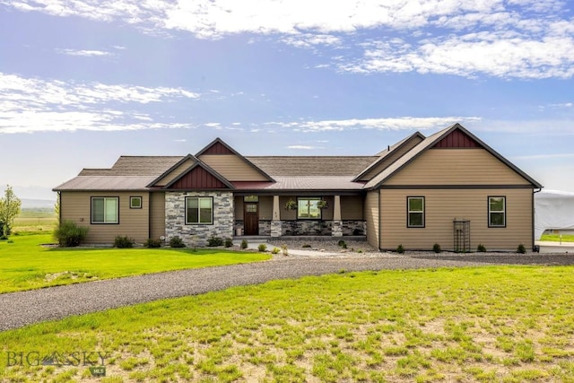 43 Lewis Dr, Three Forks, MT 59752 - view of front of home featuring covered porch, a front lawn, stone siding, board and batten siding, and roof with shingles