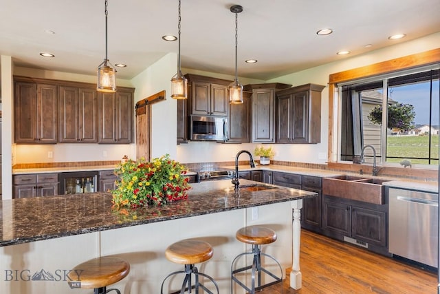 43 Lewis Dr, Three Forks, MT 59752 - kitchen with stainless steel appliances, wine cooler, a sink, dark brown cabinetry, and recessed lighting