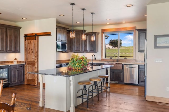 43 Lewis Dr, Three Forks, MT 59752 - kitchen featuring stainless steel appliances, a sink, wine cooler, an island with sink, and recessed lighting