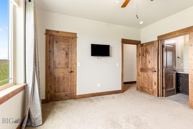 43 Lewis Dr, Three Forks, MT 59752 - unfurnished bedroom with carpet flooring, baseboards, connected bathroom, and ceiling fan