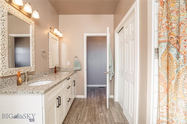 6 Wild Rye Pl, Three Forks, MT 59752 - bathroom with double vanity, baseboards, and wood finished floors