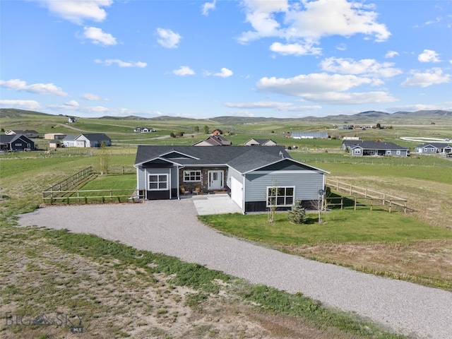 6 Wild Rye Pl, Three Forks, MT 59752 - view of front facade featuring gravel driveway, a mountain view, and a view of countryside