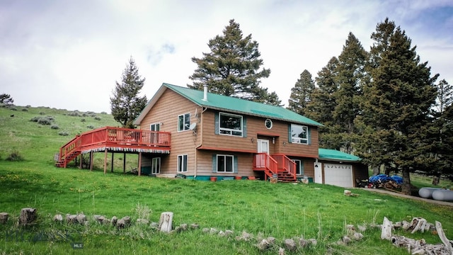 263 Hercules Rd, Emigrant, MT 59027 - bi-level home featuring a deck, stairs, a front yard, and an attached garage
