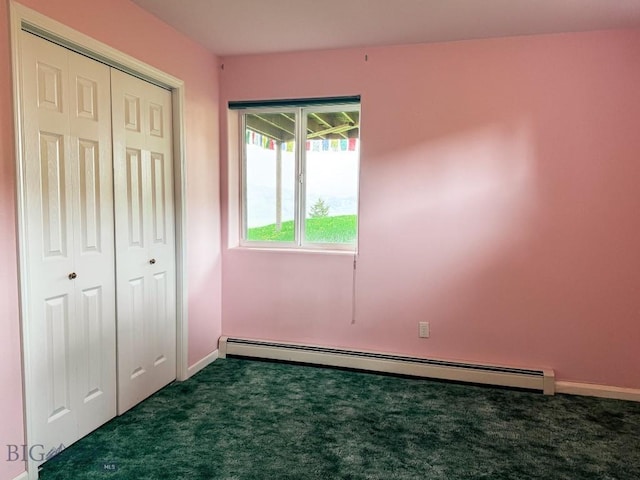 263 Hercules Rd, Emigrant, MT 59027 - unfurnished bedroom with a baseboard heating unit, dark colored carpet, baseboards, and a closet