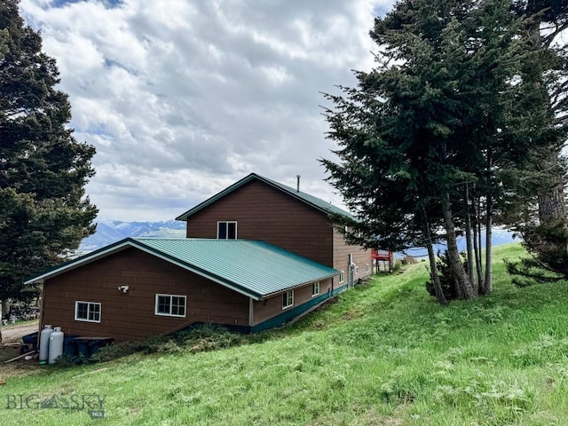 263 Hercules Rd, Emigrant, MT 59027 - view of home's exterior with metal roof, a yard, and a mountain view