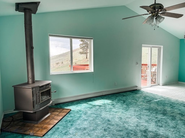 263 Hercules Rd, Emigrant, MT 59027 - unfurnished living room with baseboard heating, a wood stove, vaulted ceiling, a ceiling fan, and carpet floors